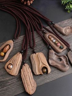 wooden necklaces with beads and stones on a table