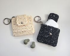 two crocheted items are sitting next to each other on a white table top