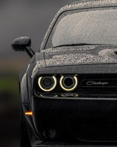 the front end of a black sports car