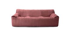 a pink corded couch sitting on top of a white floor