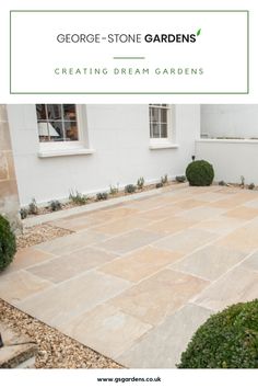 an image of a stone patio with plants in the front yard and landscaping on the other side