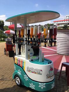 a small ice cream cart with drinks on top