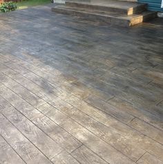 an outdoor patio with steps leading up to the front door and stairs on either side