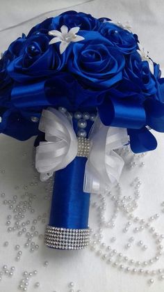 a bridal bouquet with blue roses and pearls