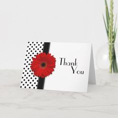 a thank card with a red flower on it