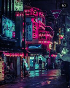 a city street at night with neon signs and people holding umbrellas in the rain