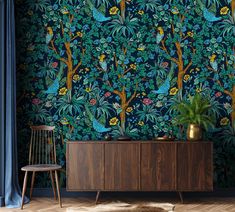 a blue wallpaper with trees and birds in the forest, next to a chair