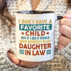 a woman holding a coffee mug that says i don't have a favorite child but if it would most definitely be my daughter in law