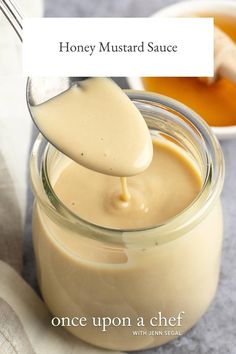 a spoon full of honey mustard sauce being poured into a jar with the recipe below it