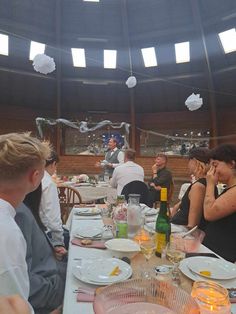 a group of people sitting around a dinner table