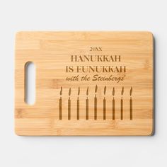 a bamboo cutting board with the words hanukkah is funkrah and five candles