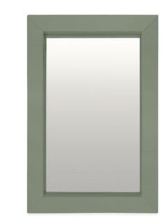 a green frame mirror on a white wall with an empty space for the reflection in it