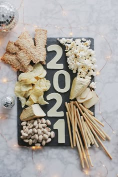 a black board topped with cheese and crackers