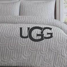 the ugg bedding is white and has black letters on it