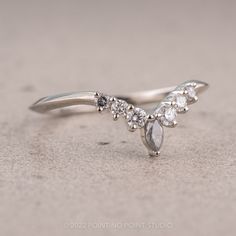 a close up of a diamond ring on a table with the top half showing diamonds