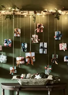 christmas decorations hanging on the wall with pictures and lights above them in a dining room