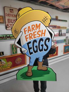 a person holding up a sign that says farm fresh eggs