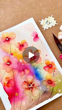 watercolor flowers are being used to make an art project