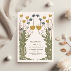 a wedding card with flowers and leaves on it