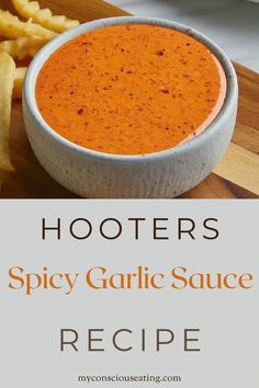 a bowl of spicy garlic sauce on a cutting board next to some french fries with the words, hooters spicy garlic sauce recipe