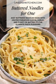 a white bowl filled with pasta and parmesan cheese