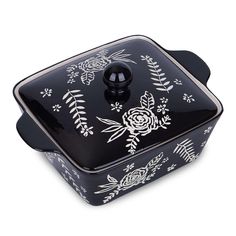 a black and white casserole dish with floral designs