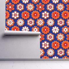 an orange and blue flower pattern on a wall