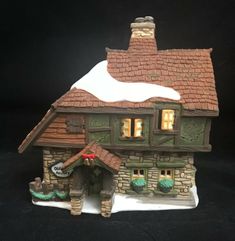 a figurine of a house with snow on the roof