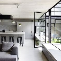 a living room filled with furniture and lots of windows