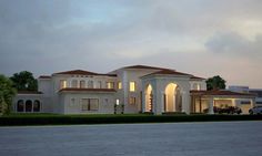 a large white house sitting on top of a lush green field next to a parking lot