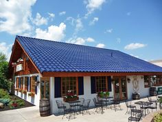 the outside of a restaurant with tables and chairs