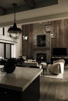 a living room filled with furniture and a fire place in the middle of a room