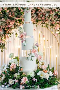 a white wedding cake with pink flowers and greenery