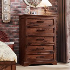 a bedroom scene with focus on the chest of drawers and brick wall in the background