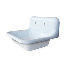 a white sink sitting on top of a counter next to a wall mounted faucet