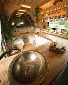 a bowl shaped sink sitting on top of a wooden counter