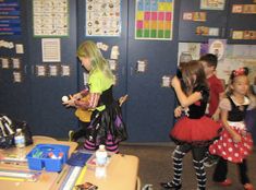 children in costumes standing around a table