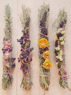 four bundles of dried flowers tied together