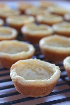 several small cupcakes sitting on top of a cooling rack