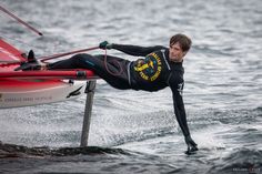 a man riding on top of a boat in the ocean