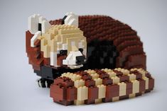 a lego cow laying on top of a pile of bricks