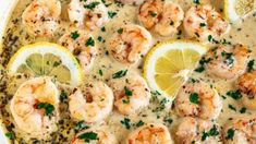 a bowl filled with shrimp and lemon soup