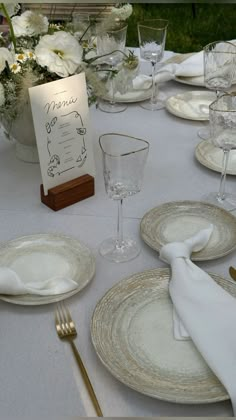 the table is set with plates and silverware for an elegant wedding reception or special event