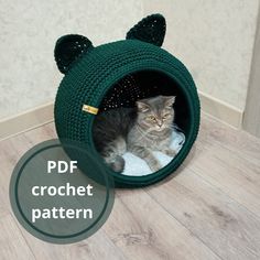 a cat is sitting in a knitted animal bed