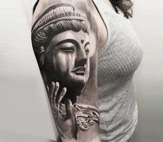 a woman's arm with a buddha tattoo on the left side of her body