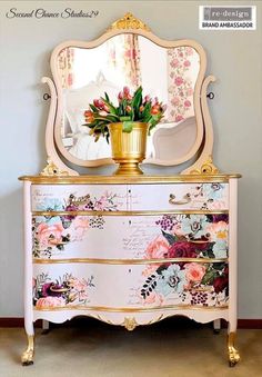 an ornate dresser with flowers painted on it