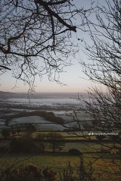 the view from an overlook looking down on foggy fields and hills in the distance