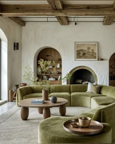 a living room filled with furniture and a fire place in the middle of the room