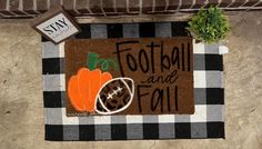 a door mat that says football and fall on it with a pumpkin next to it