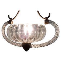 a glass and metal light fixture with two lights on each side of the lamp holder